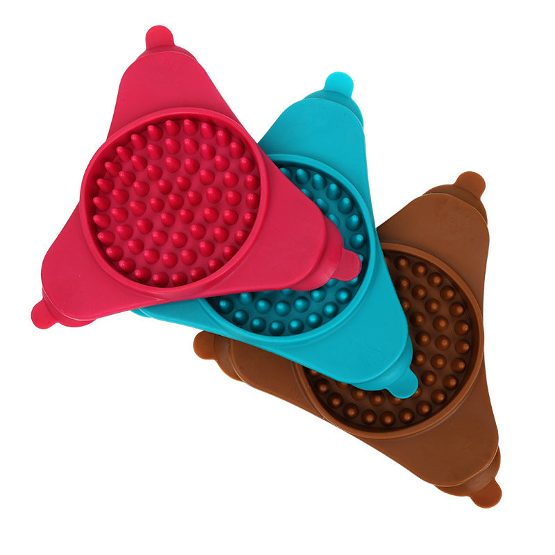 Three colorful silicone cups with textured bottoms on a white background