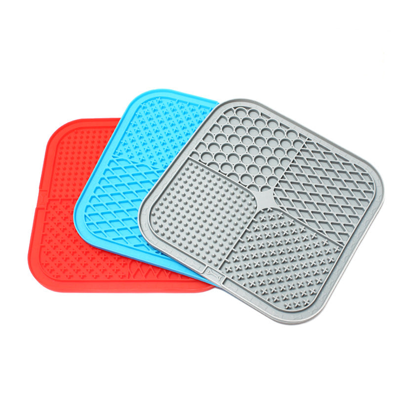 Three silicone mats in red, blue, and grey on a white background
