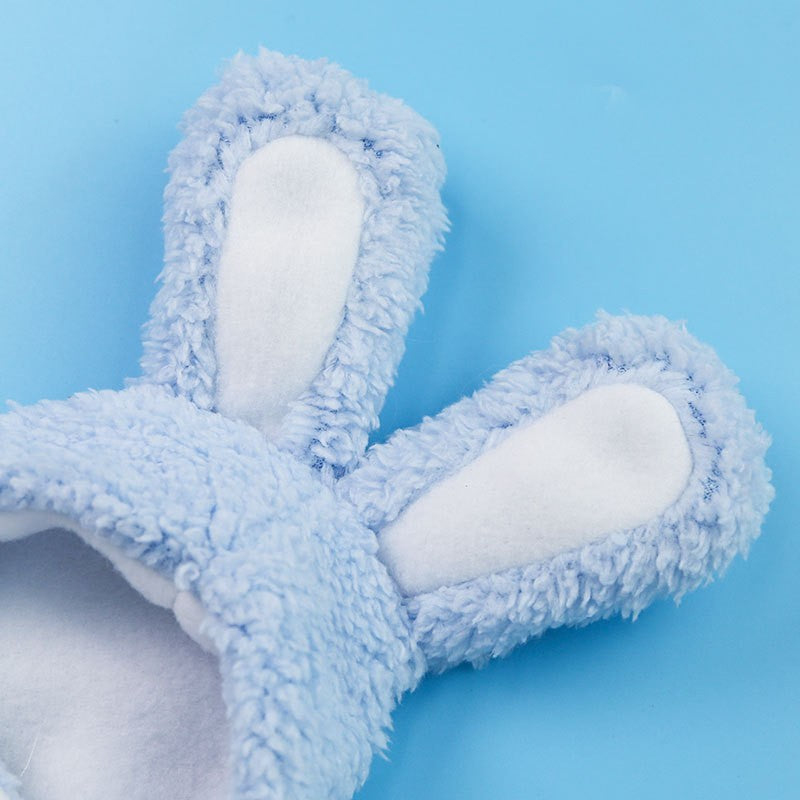 Blue fuzzy hat ears on a light blue background