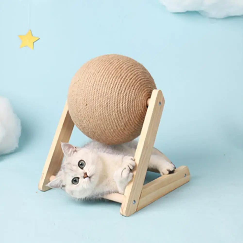 Cat playing with a ball on a wooden stand against a light blue background