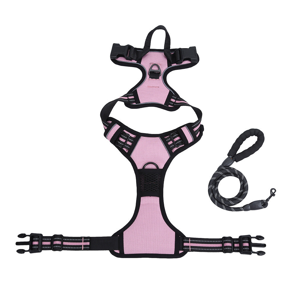 Pink dog harness with black straps and a matching leash on a white background