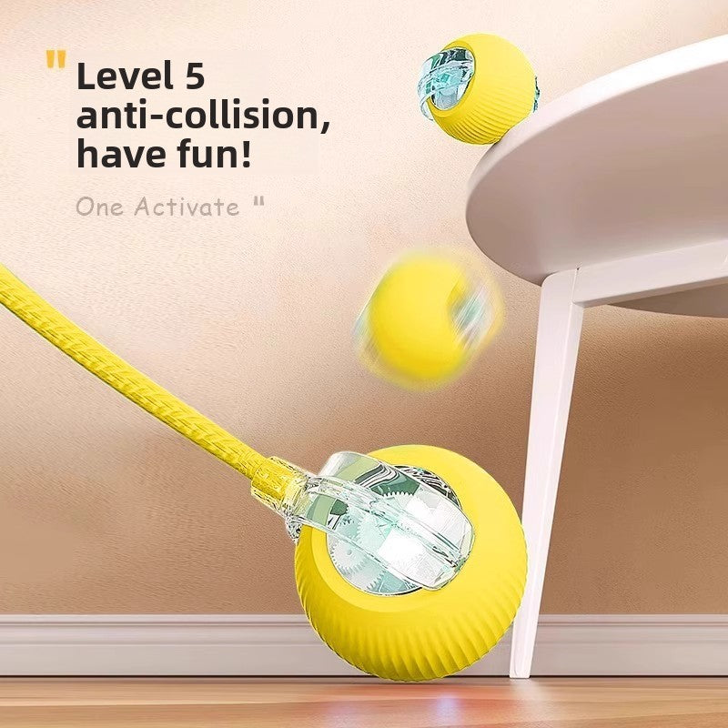 Yellow dog toy with a clear ball inside, attached to a rope, on a wooden floor.
