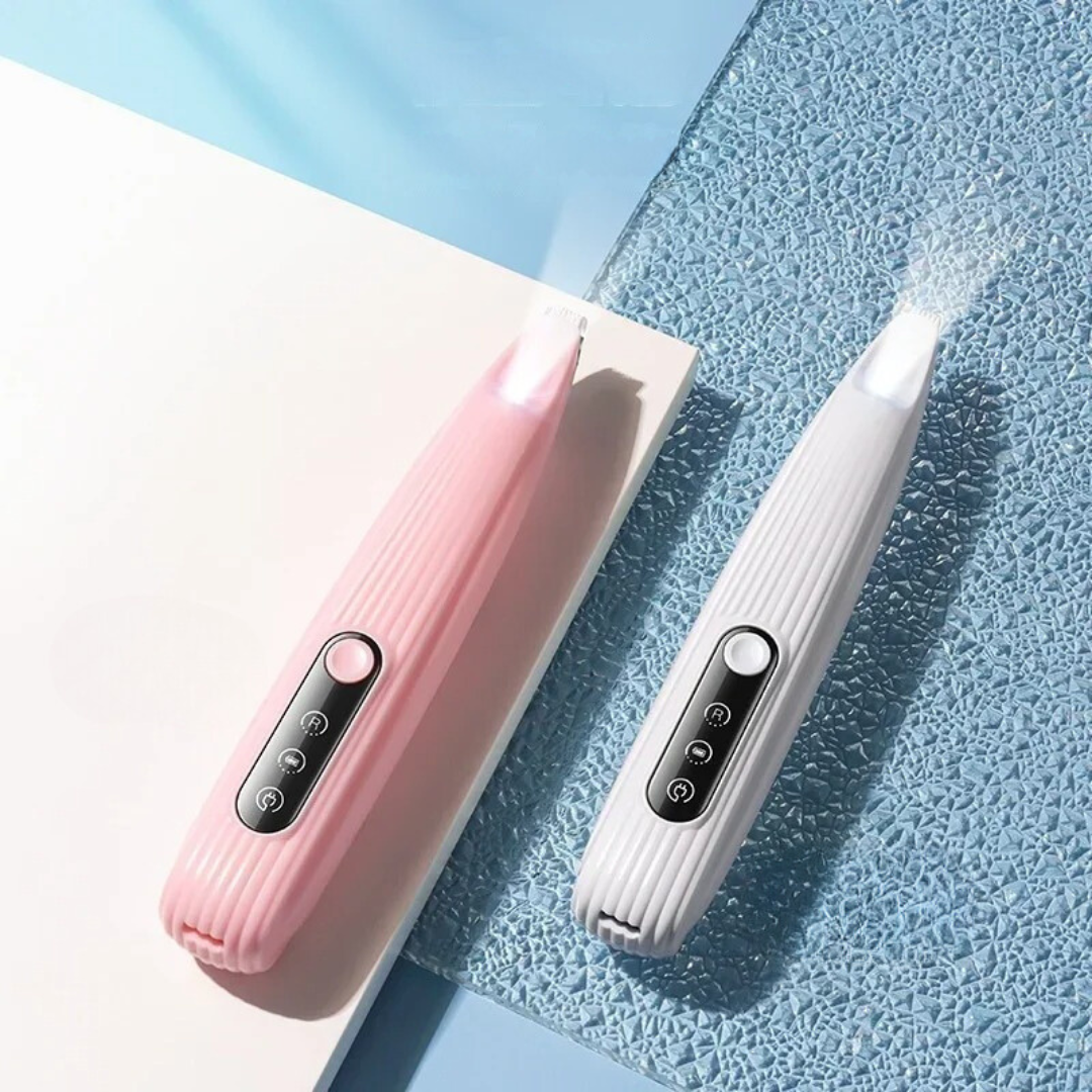 Pink and white handheld paw and fur trimmers on a textured blue surface
