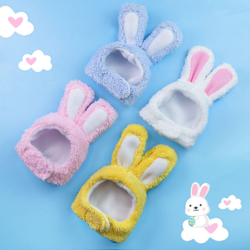 Four colourful bunny hats on a blue background with cartoon rabbit illustrations.