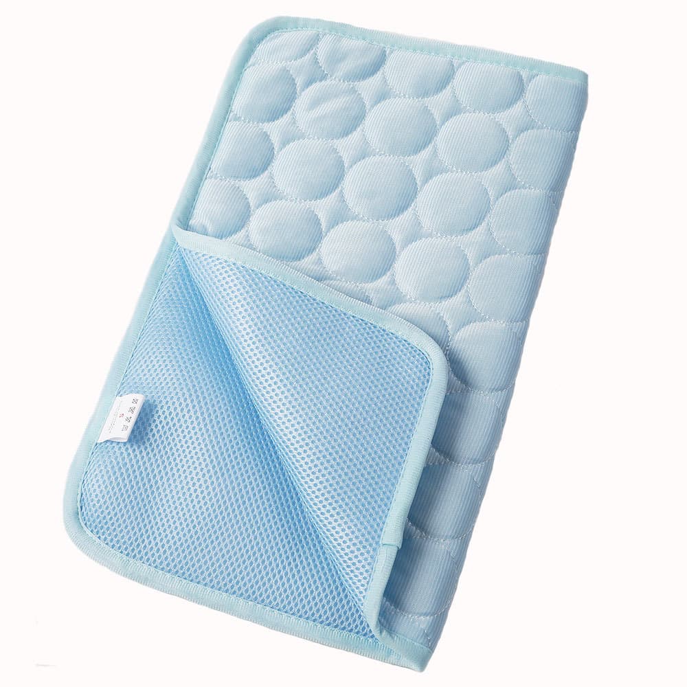 Blue quilted cooling mat with a textured surface on a white background