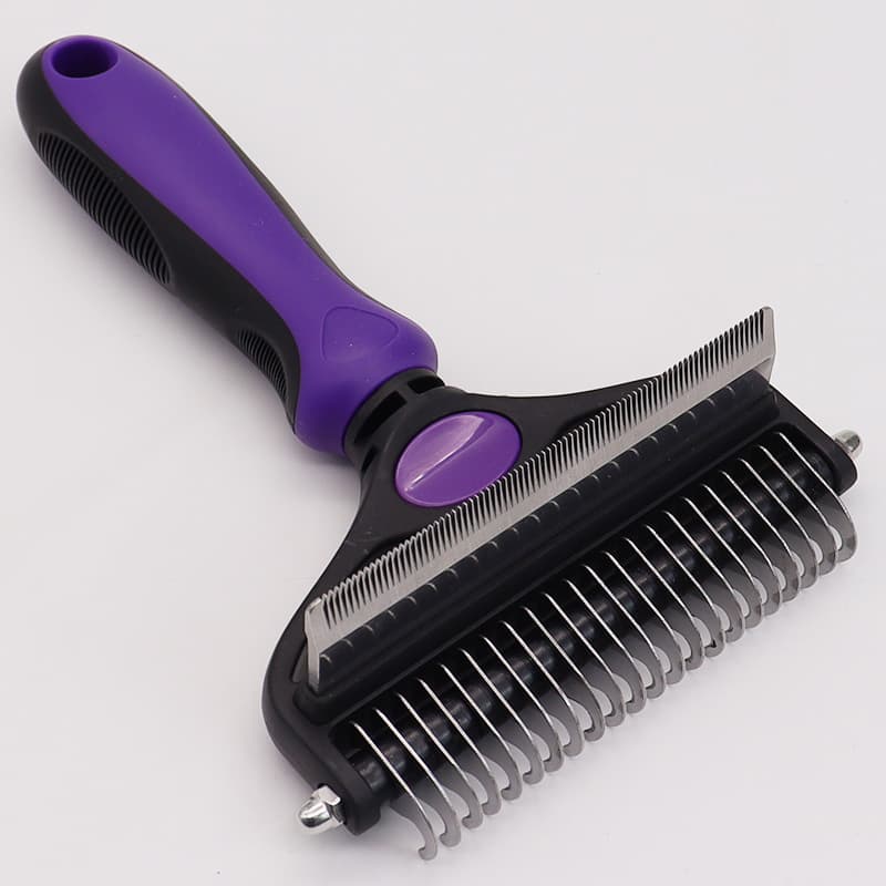 Pet grooming brush with purple handle on a white background