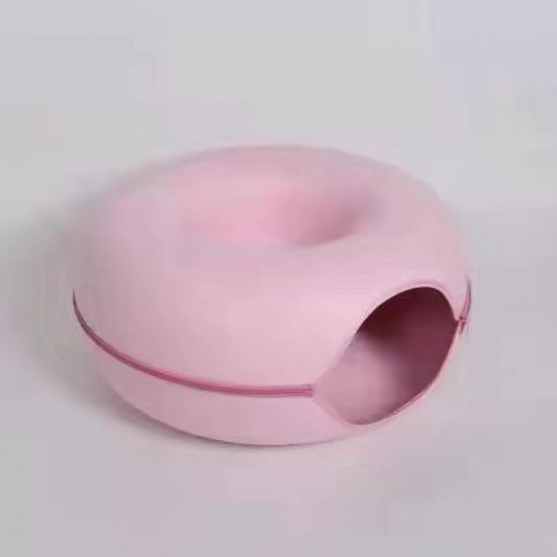 Pink oval cat bed on a light grey background