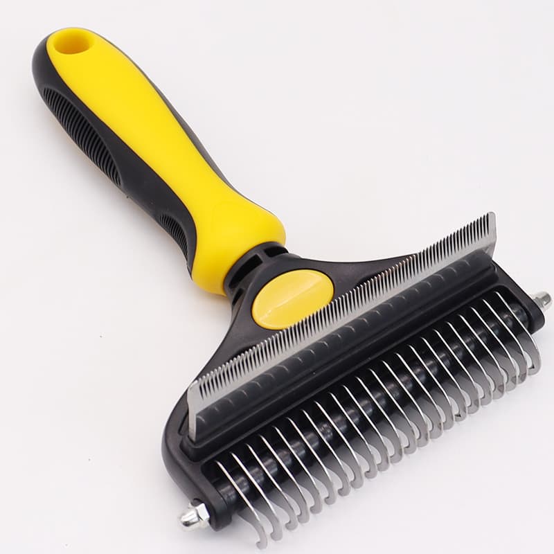 Pet grooming brush with yellow handle on a white background
