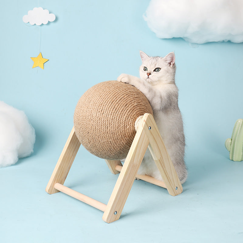 Cat playing with a spherical scratching post on a light blue background with decorative clouds and stars.