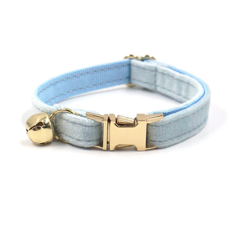 Pet collar with gold clasp and bell on a white background