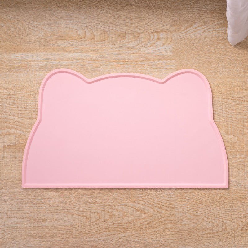 Pink cat ear-shaped mat on a wooden floor