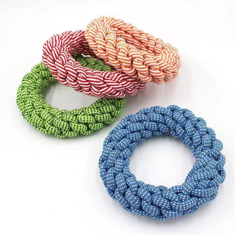 4 dog rope toys, blue, green, red and orange on a white background.