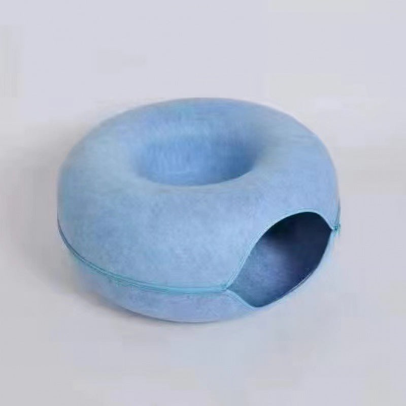 Blue donut-shaped pillow on a light grey background