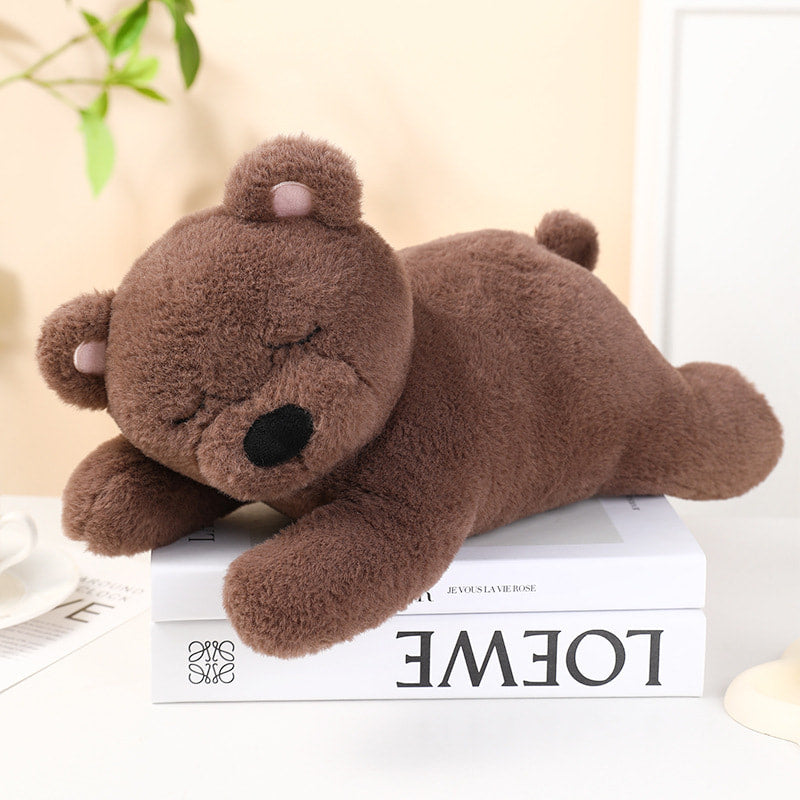Brown teddy bear plush toy on a book with a light background