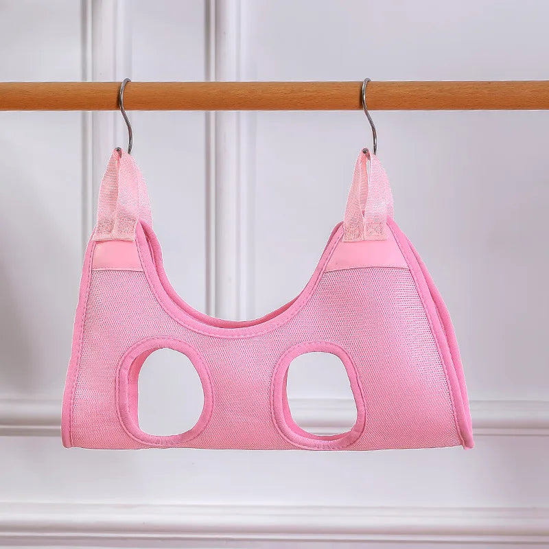 Pink cat harness on a wooden rod against a white background