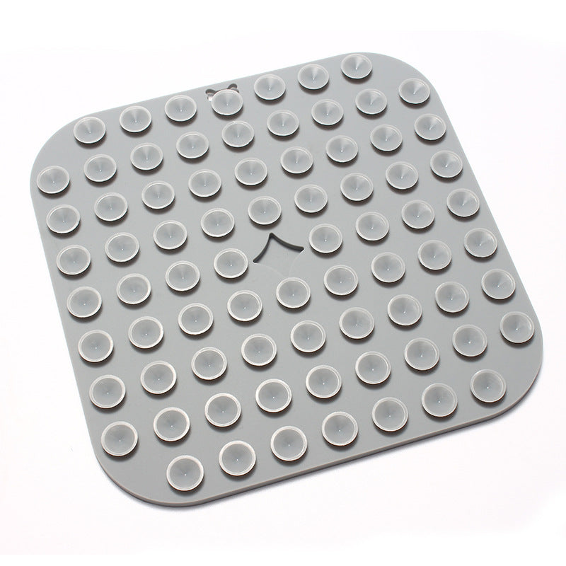 Grey silicone mat with round protrusions on a white background