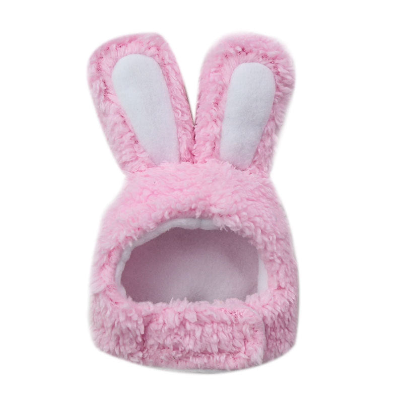 Pink fluffy pet hat with bunny ears on a white background