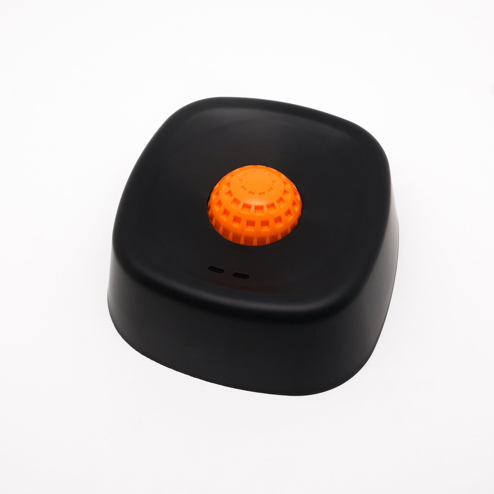 Black device with an orange button on a white background