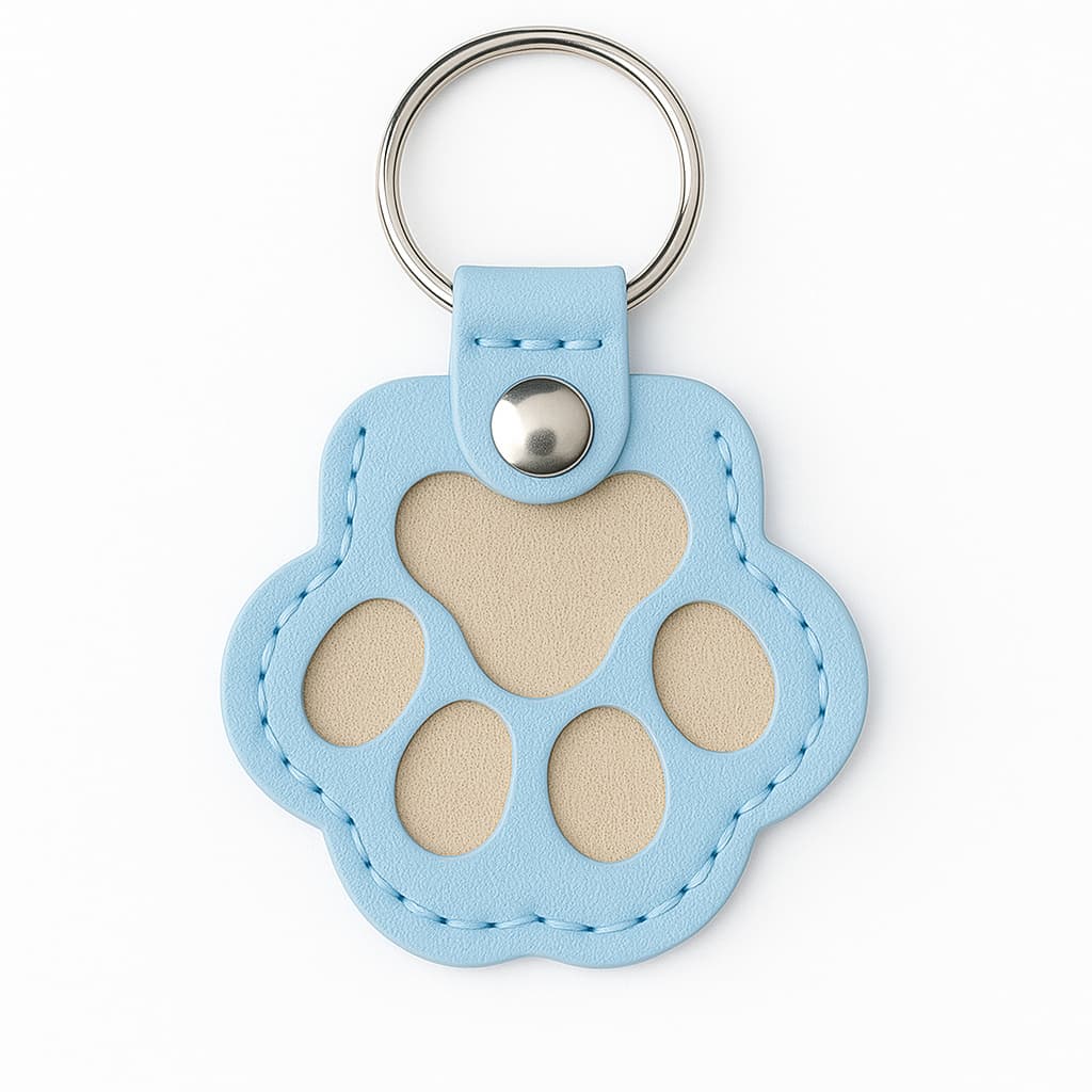 Blue paw print keychain with a silver ring on a white background