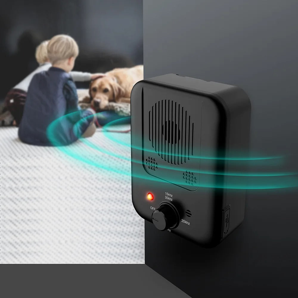 Black electronic device with sound waves emanating from it, used to stop dogs barking. ultrasonic bark stopper.