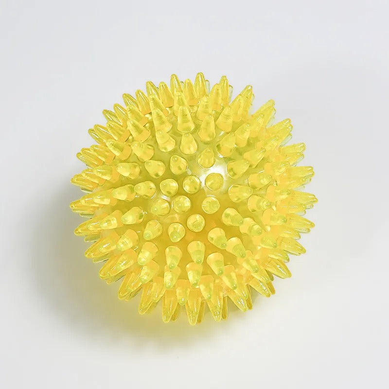 Yellow spiky ball on a light gray background