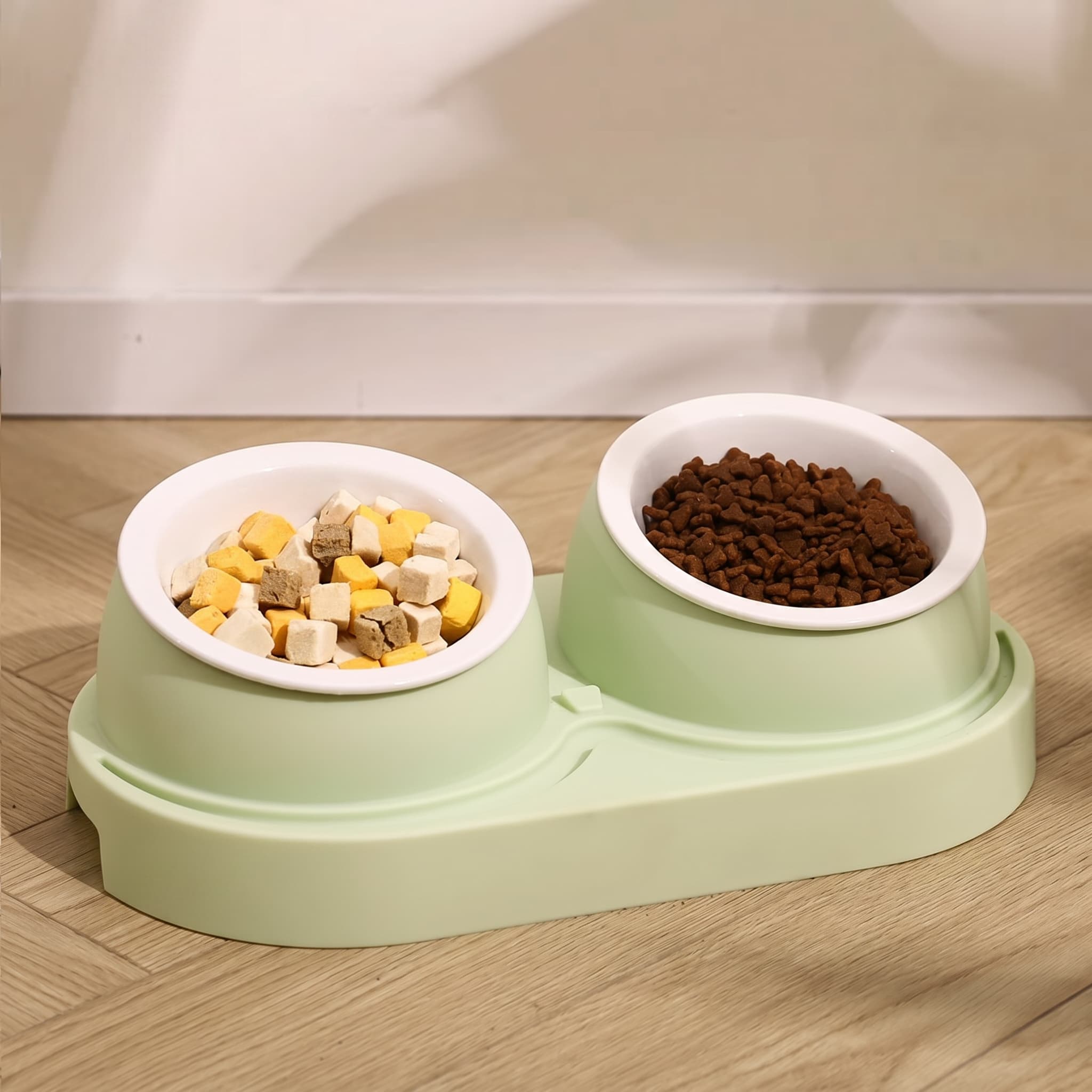Pet food bowl with two sections filled with dry and wet food on a wooden floor.