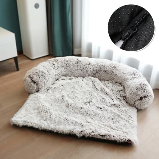 Fluffy pet bed with a zipper detail on a wooden floor.