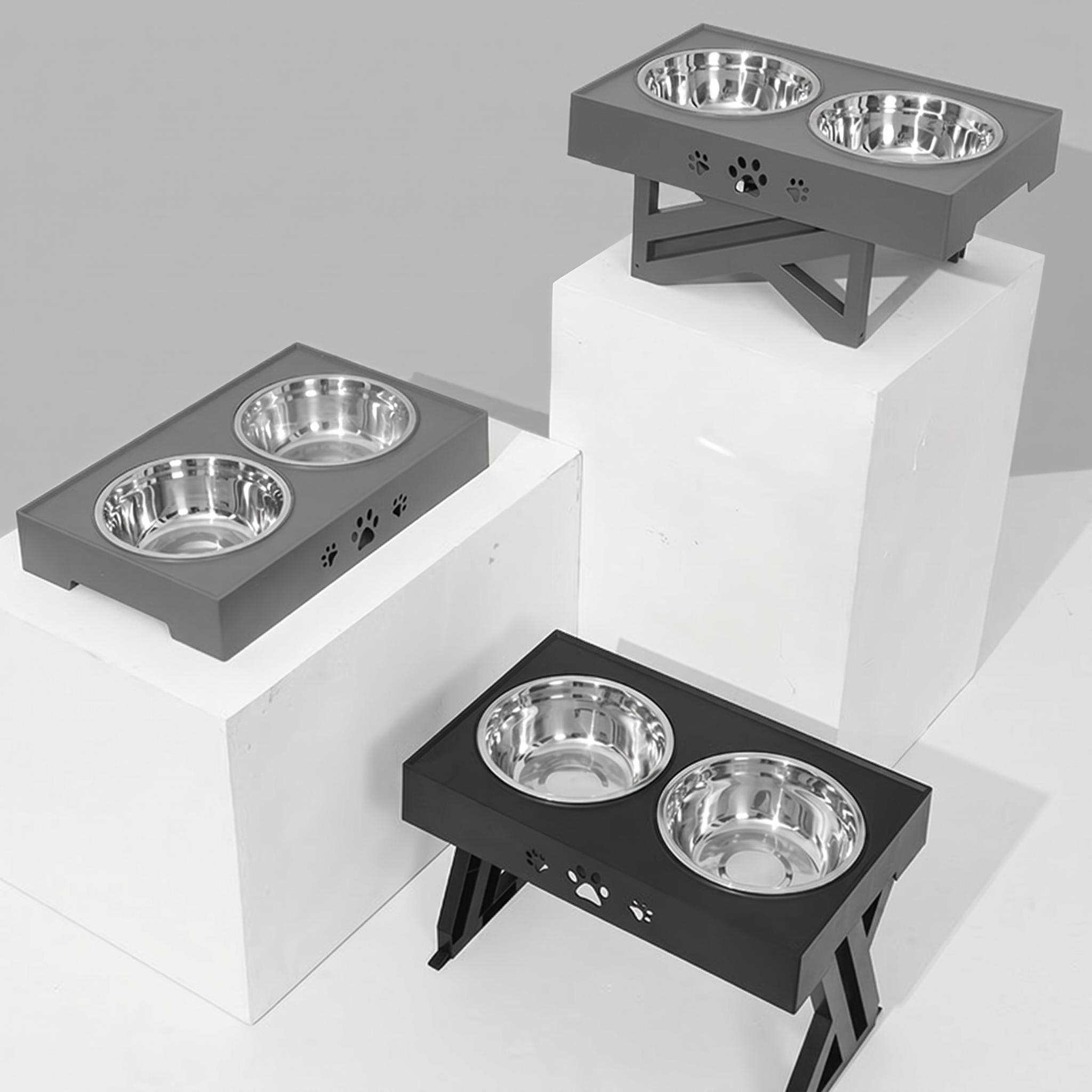 Three elevated pet feeding stations with stainless steel bowls on a white background