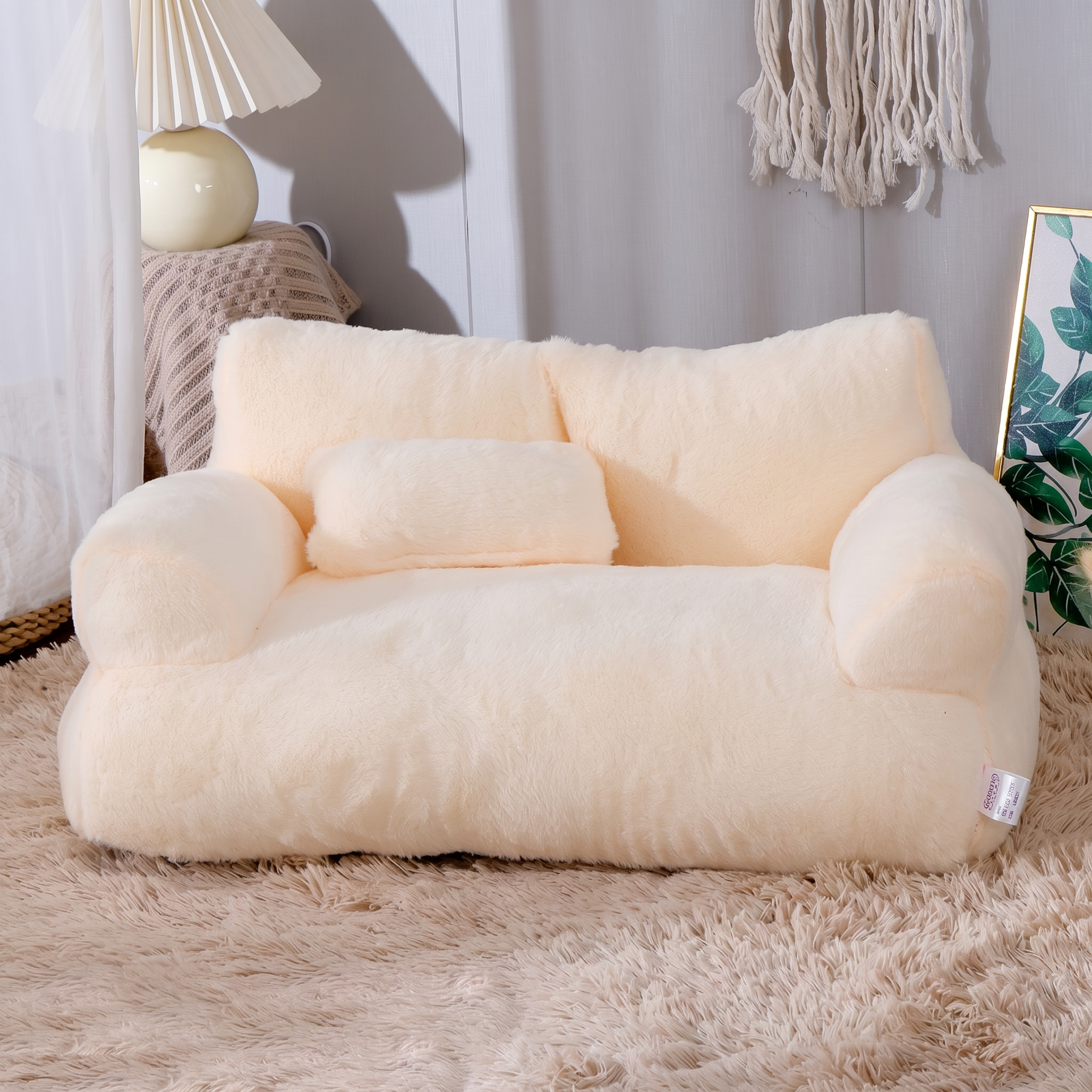 Cream-colored bean bag chair in a room with decor elements.