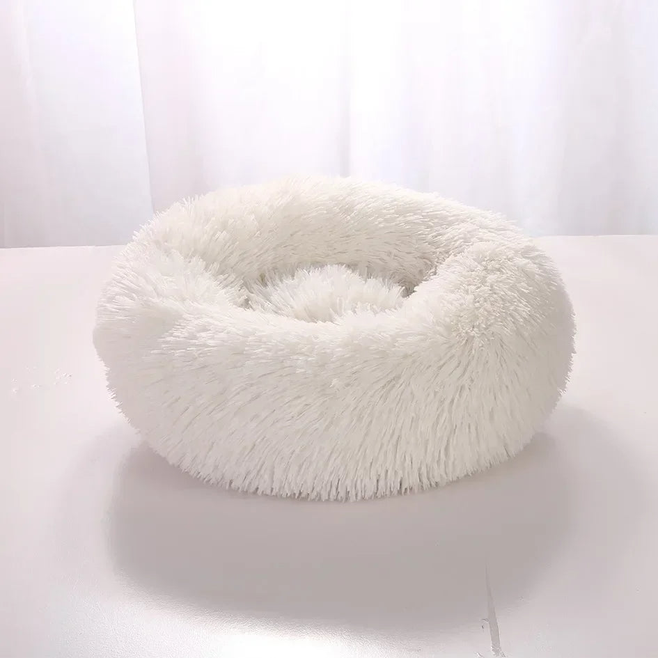 White fluffy donut-shaped pet bed on a white background