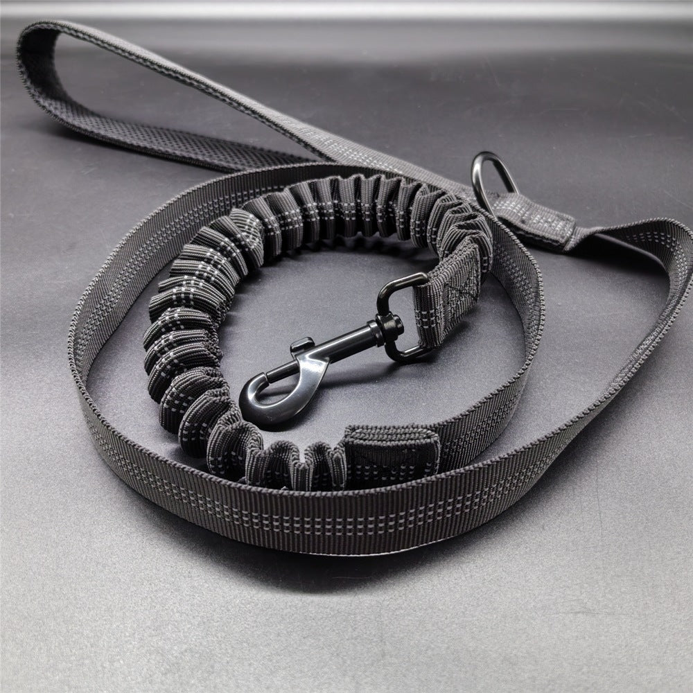 Black dog leash with handle on a gray surface