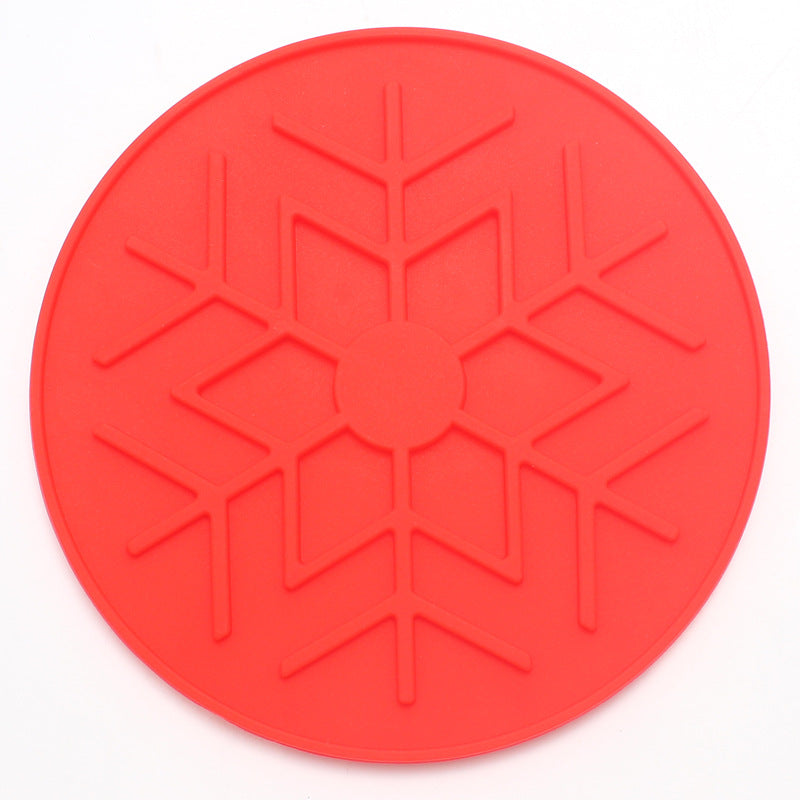 Red silicone mat with snowflake pattern on a white background
