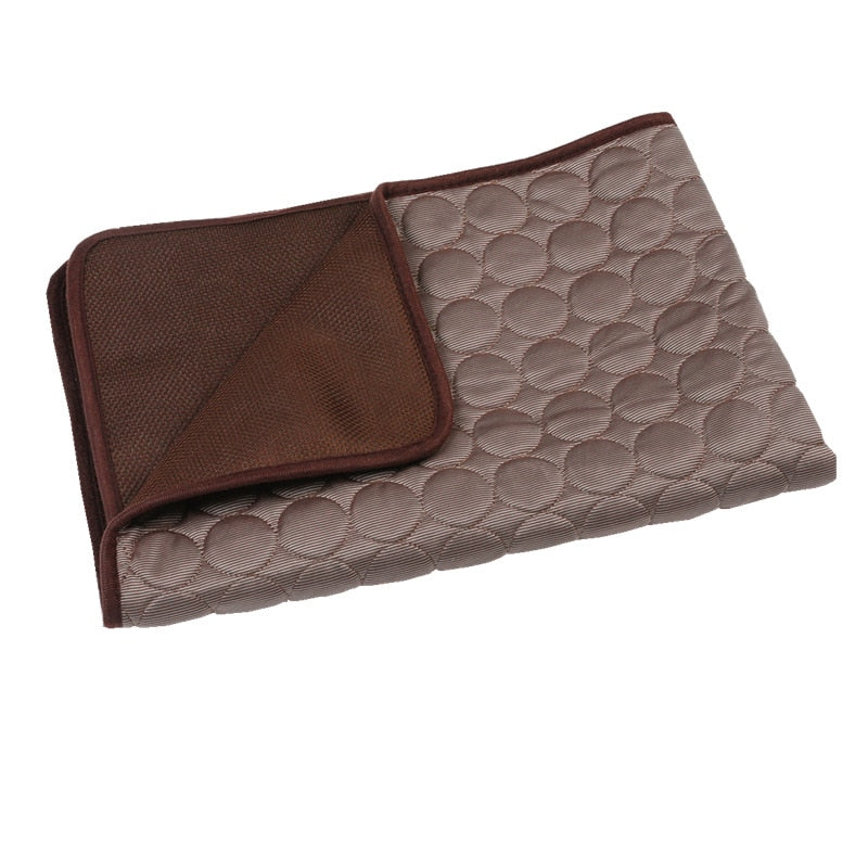 Folded self cooling mat brown and beige patterns on a white background