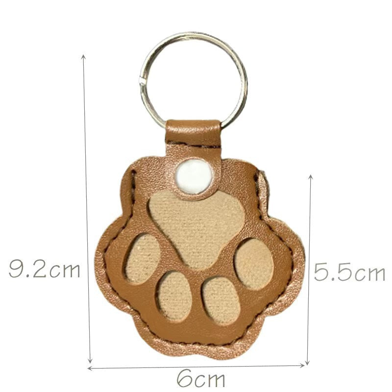 Brown paw-shaped keychain with measurements on a white background