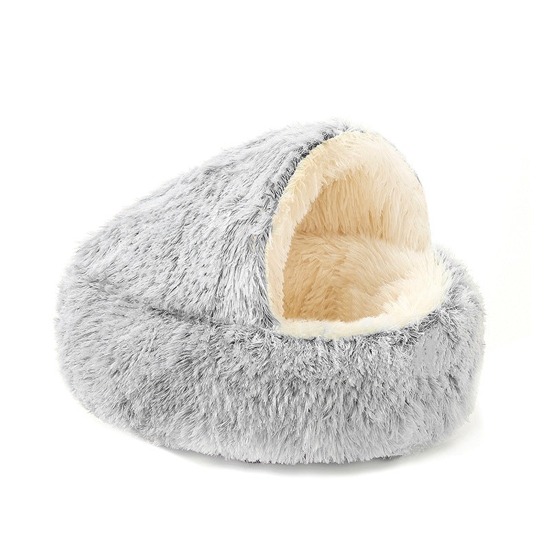 Grey fluffy pet bed with beige interior on a white background