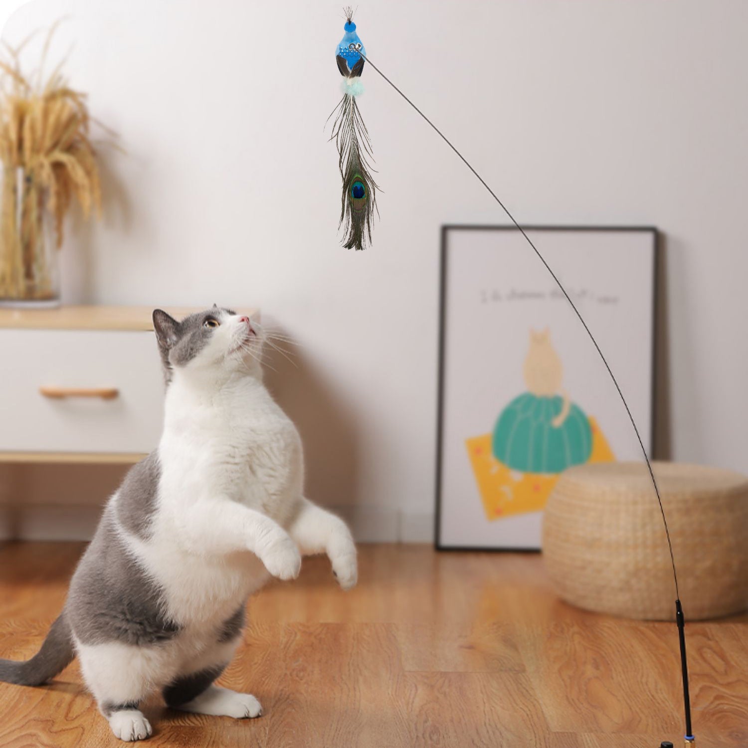 Cat playing with a feathered cat toy on a wooden floor.