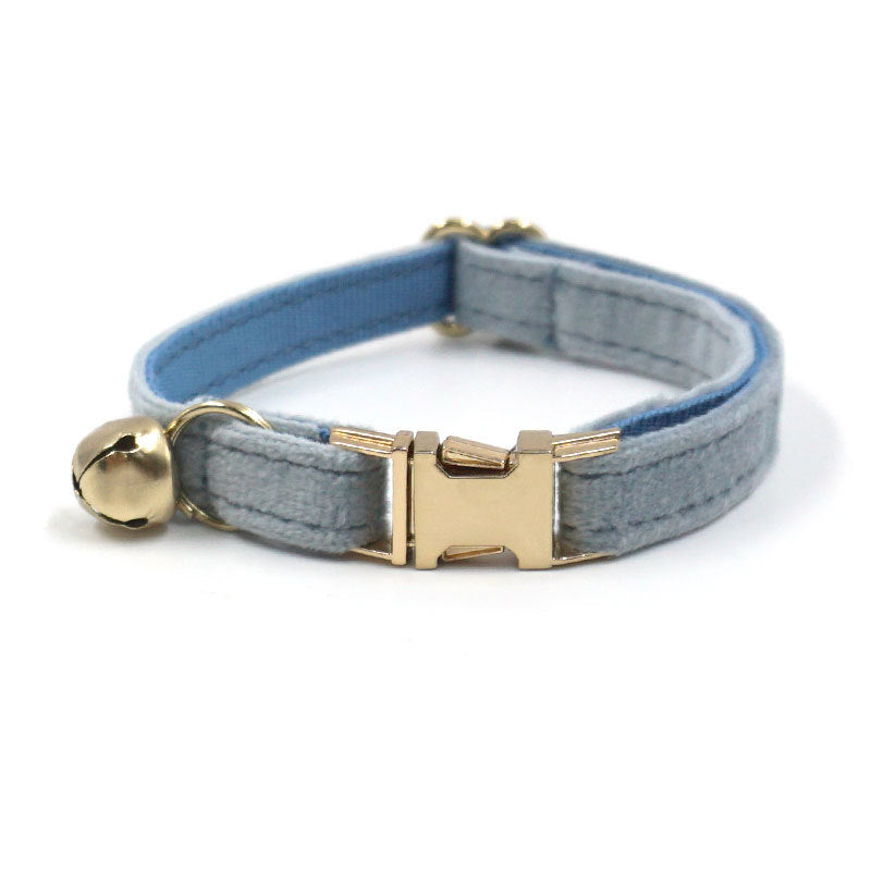 Gray and blue striped cat collar with a gold bell on a white background