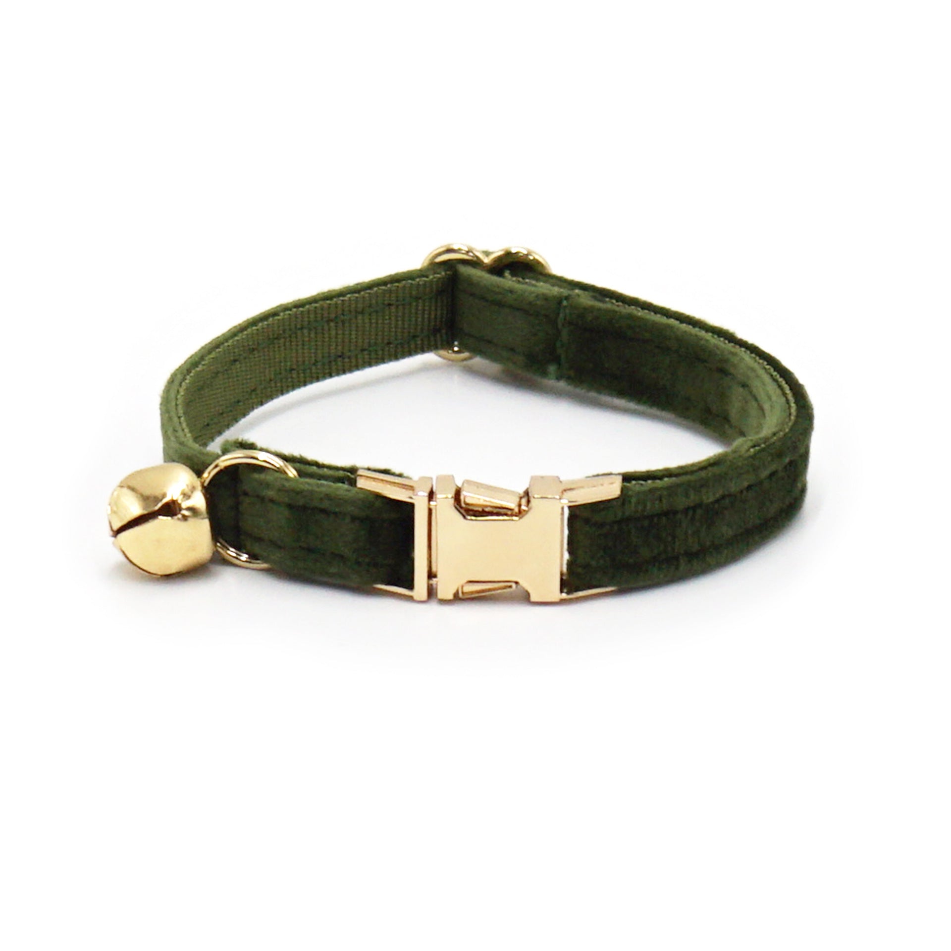 Green velvet dog collar with gold buckle and bell on a white background