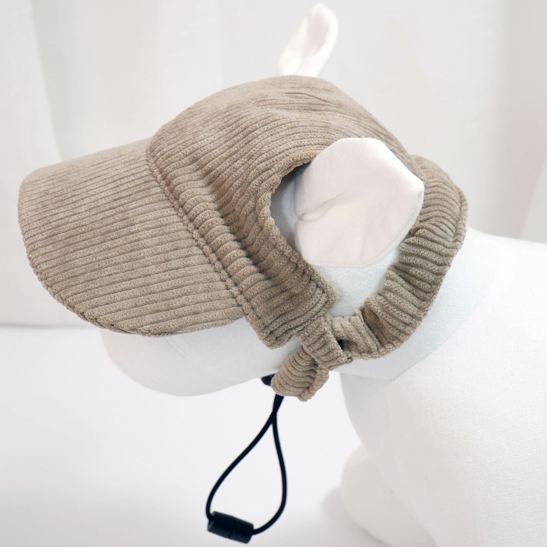 Beige knitted neck pillow on a mannequin with a white background