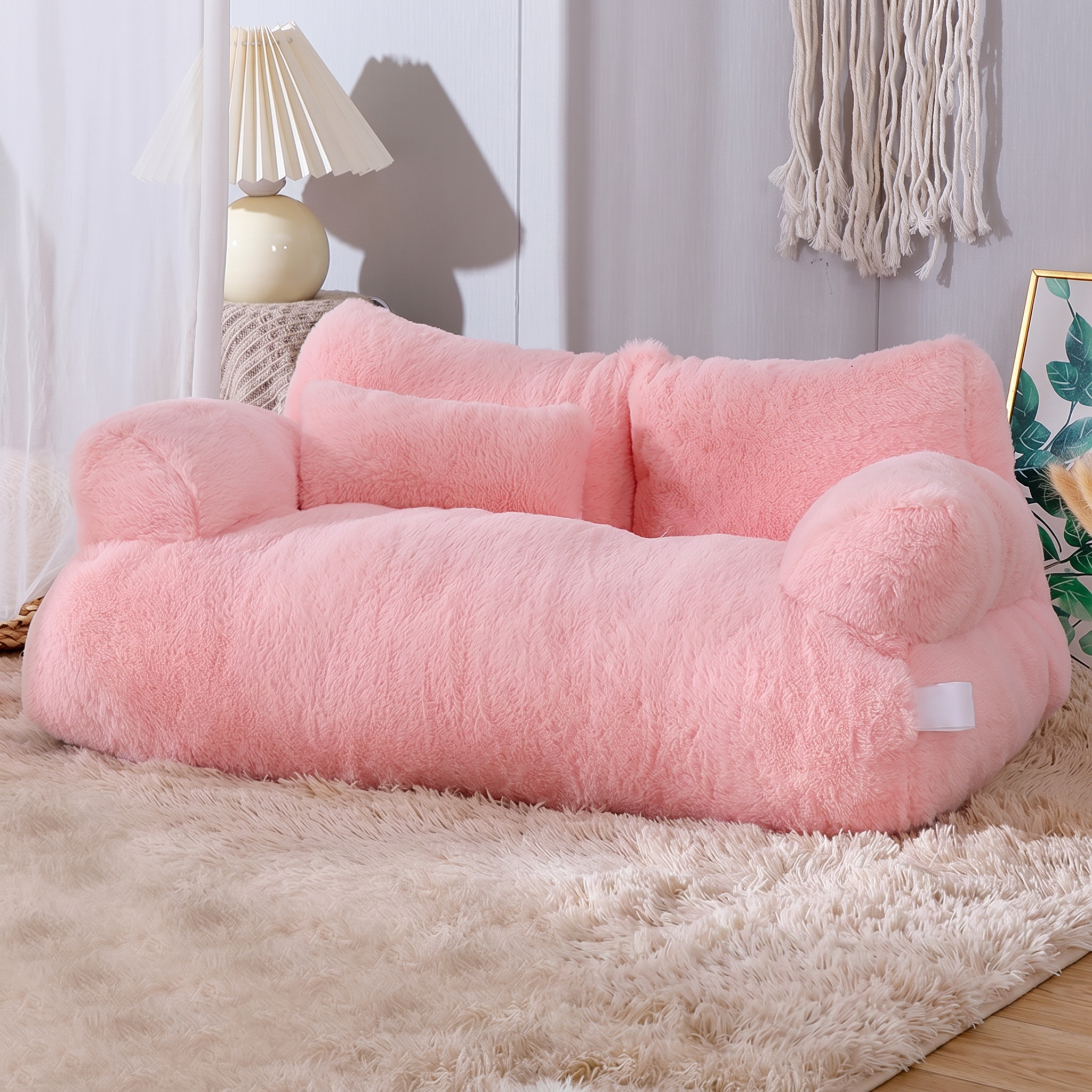 Pink pet bed on a beige carpet with a lamp and decorative items in the background
