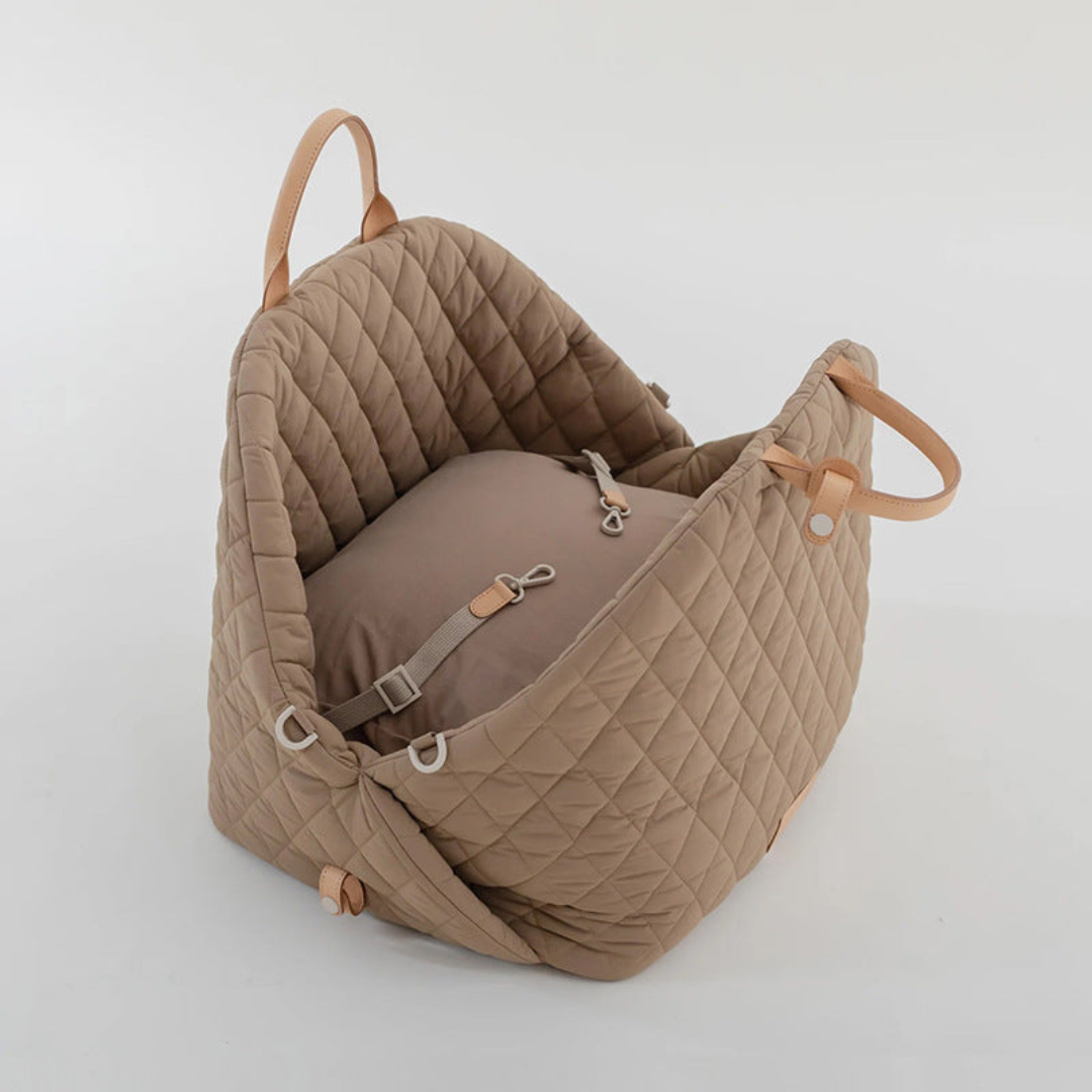 Quilted beige baby carrier on a light grey background