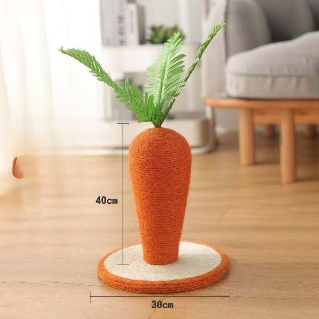 Carrot-shaped cat toy with green leaves on a wooden floor, showing measurements.