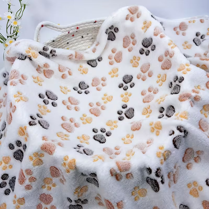Floral-patterned pet blanket with paw prints on a white background