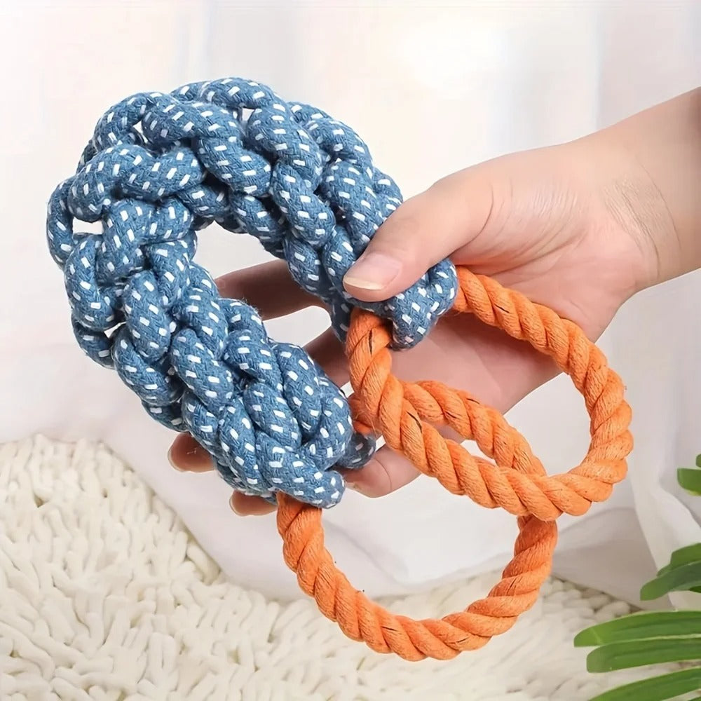 Hand holding a blue and orange rope toy on a white background