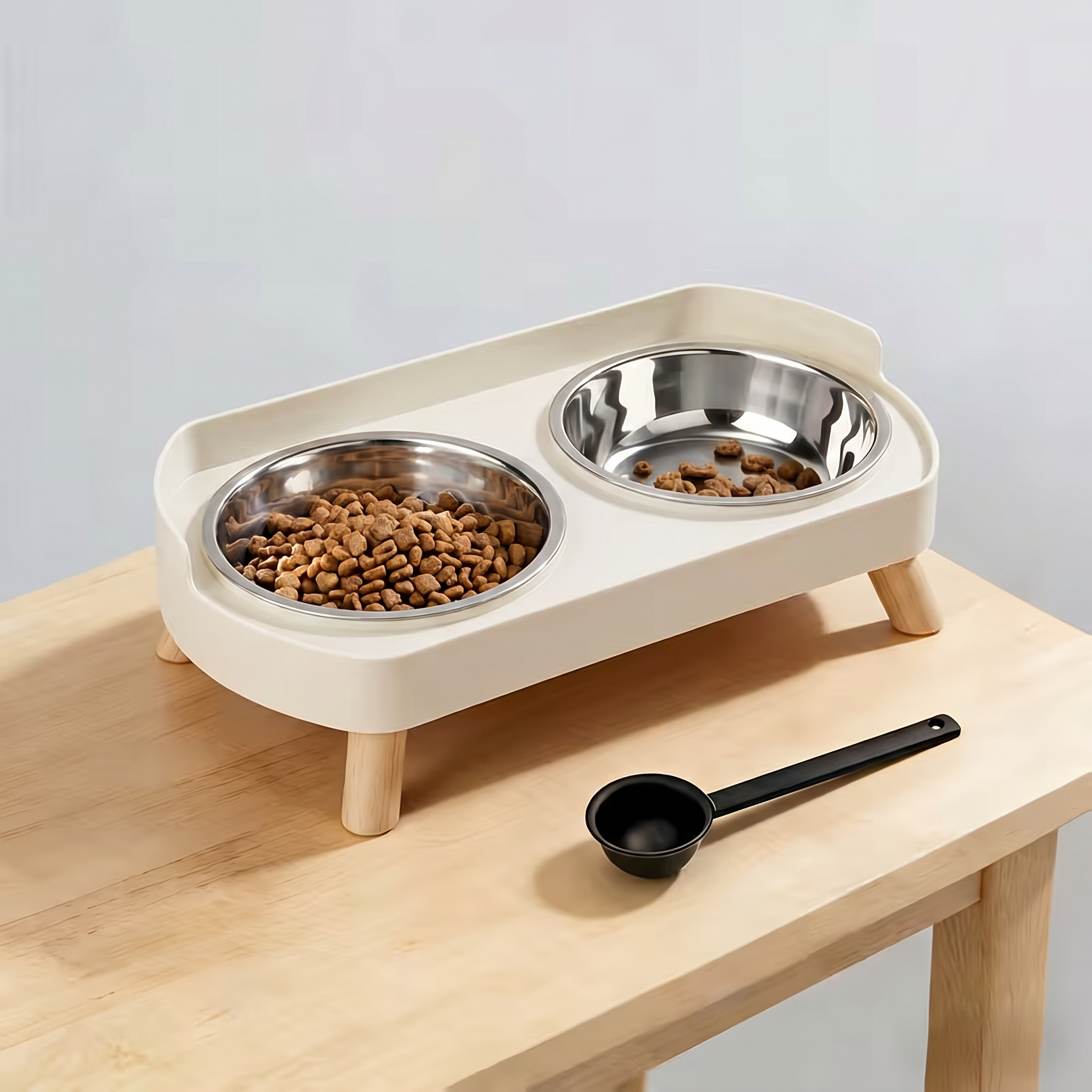 Pet feeding station with two bowls on a wooden surface