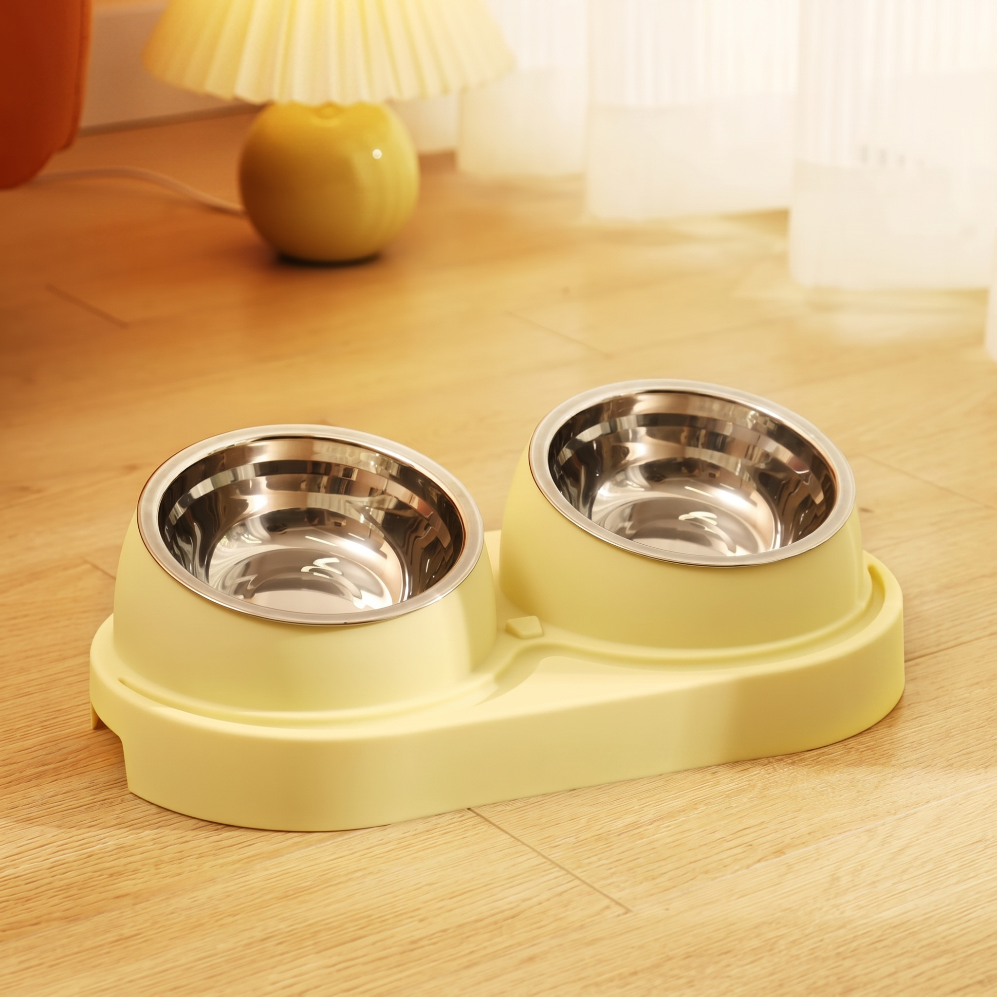 Double pet bowl with yellow base on a wooden floor