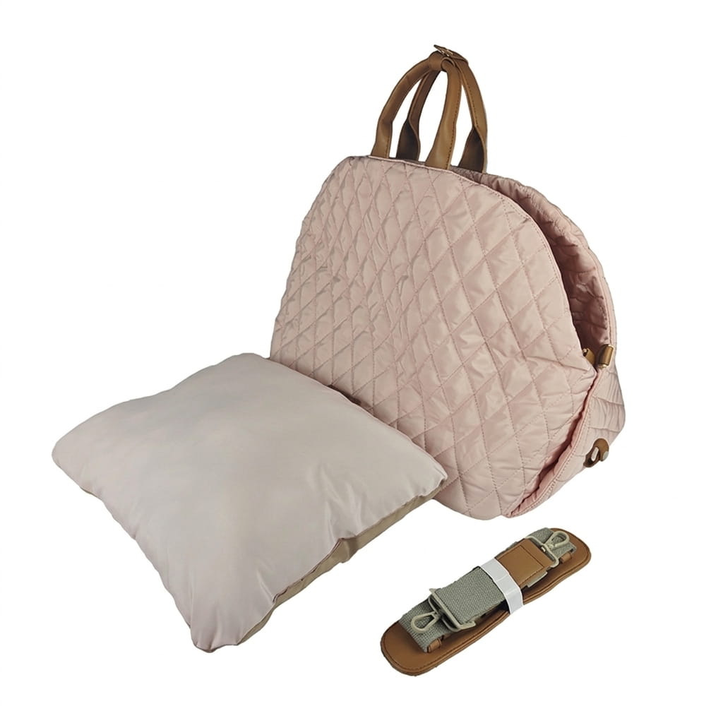 A light pink quilted handbag  shown open with a matching cream quilted insert pillow, plus a small brown-and-gray strap accessory, photographed on a plain white background.