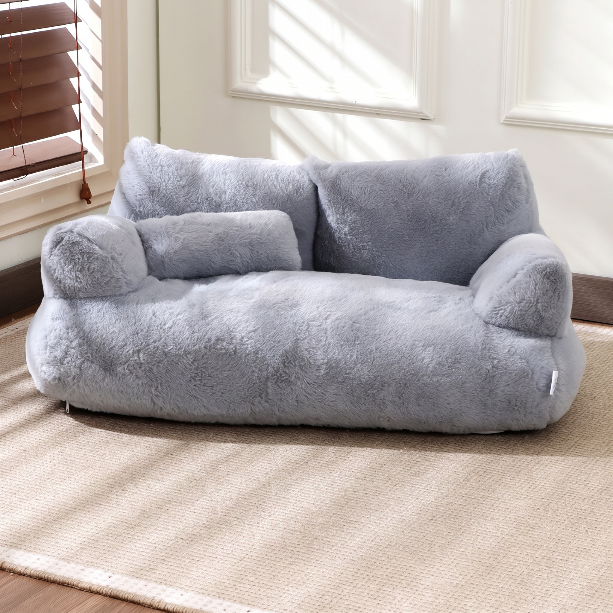 Grey fluffy bean bag chair in a room with large windows.