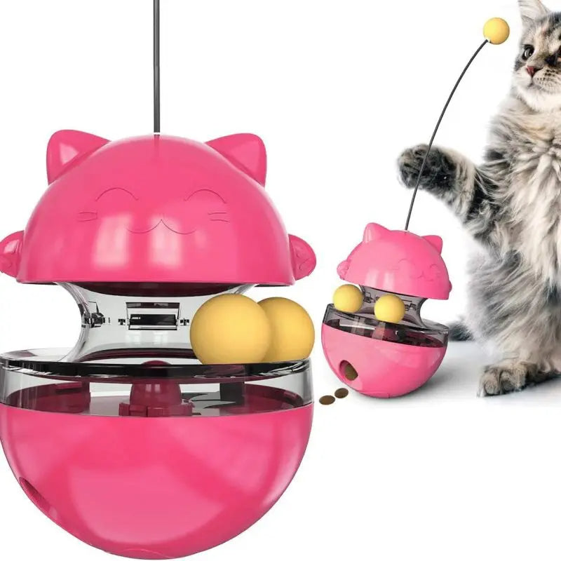Pink cat-shaped toy with yellow balls and a cat interacting with it on a white background