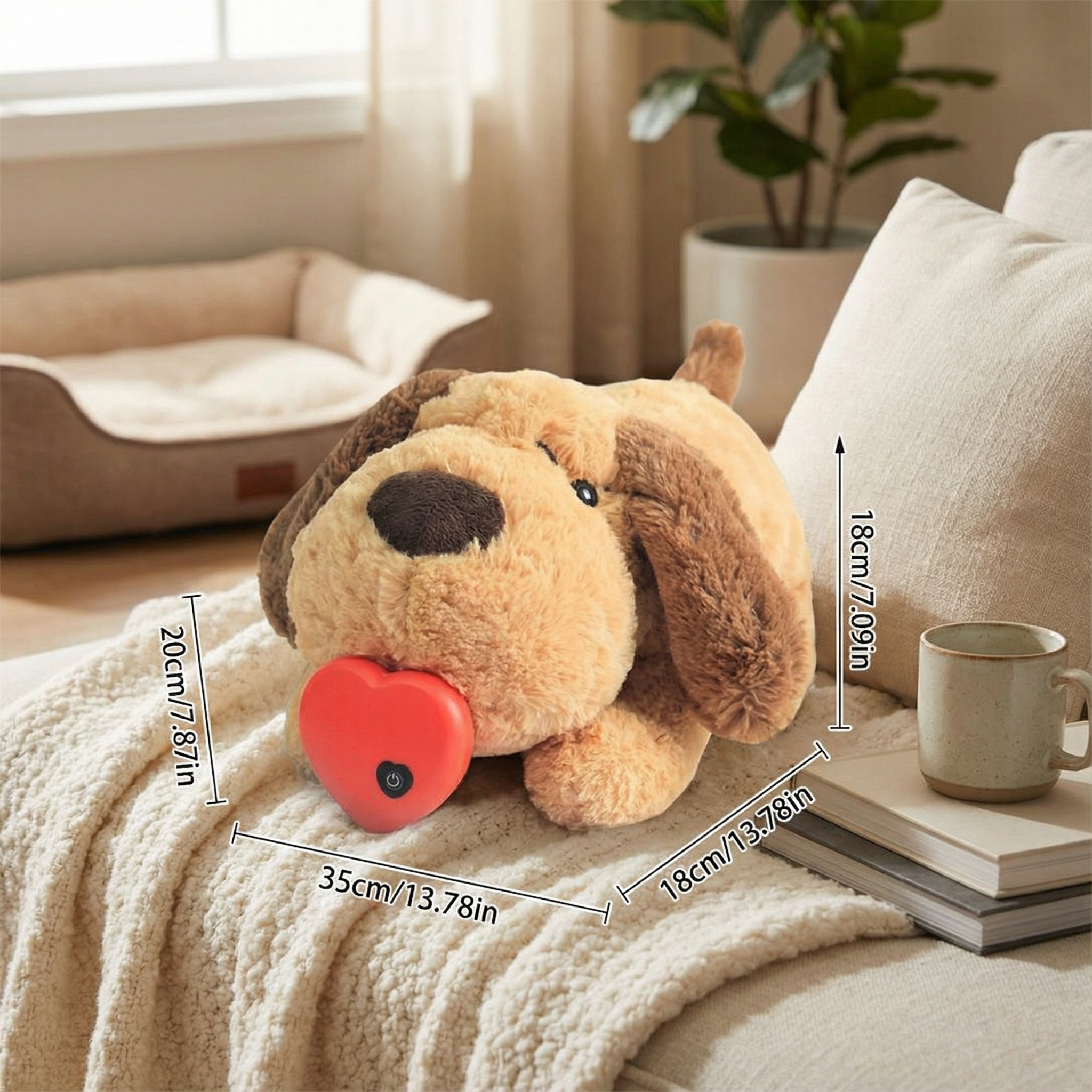 Plush dog toy with measurements on a couch next to a cup and books